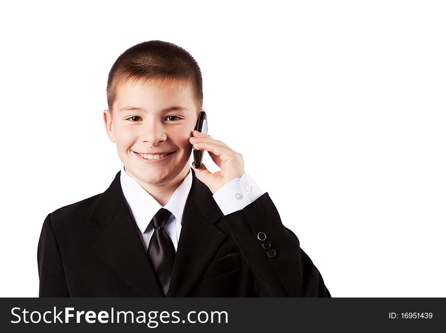 The boy speaks by phone, isolated on white