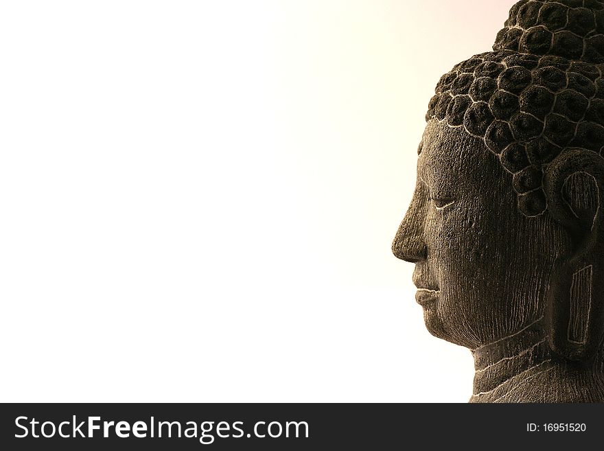 Embossed head and face of a Buddha statue.