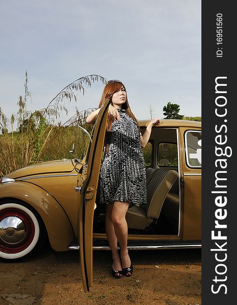 Girl posing with vintage car with blue sky. Girl posing with vintage car with blue sky