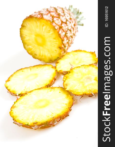 Cut pineapple isolated on white background