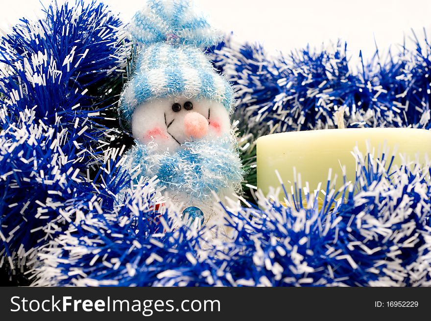 Snowman and candle with Christmas garlands on a white background. Snowman and candle with Christmas garlands on a white background