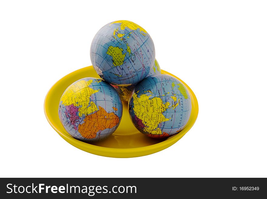 Three globes on the plate, isolated on the white. Three globes on the plate, isolated on the white
