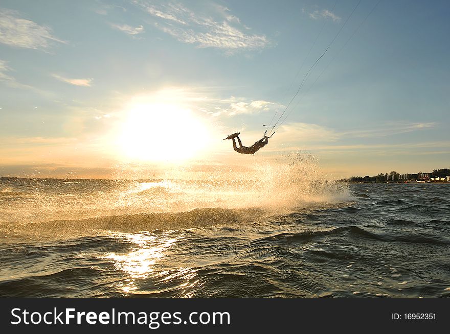 Kiteboarder jumping on a wave