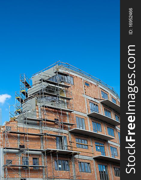 Residential building construction site on a lovely summer day (color toned image)