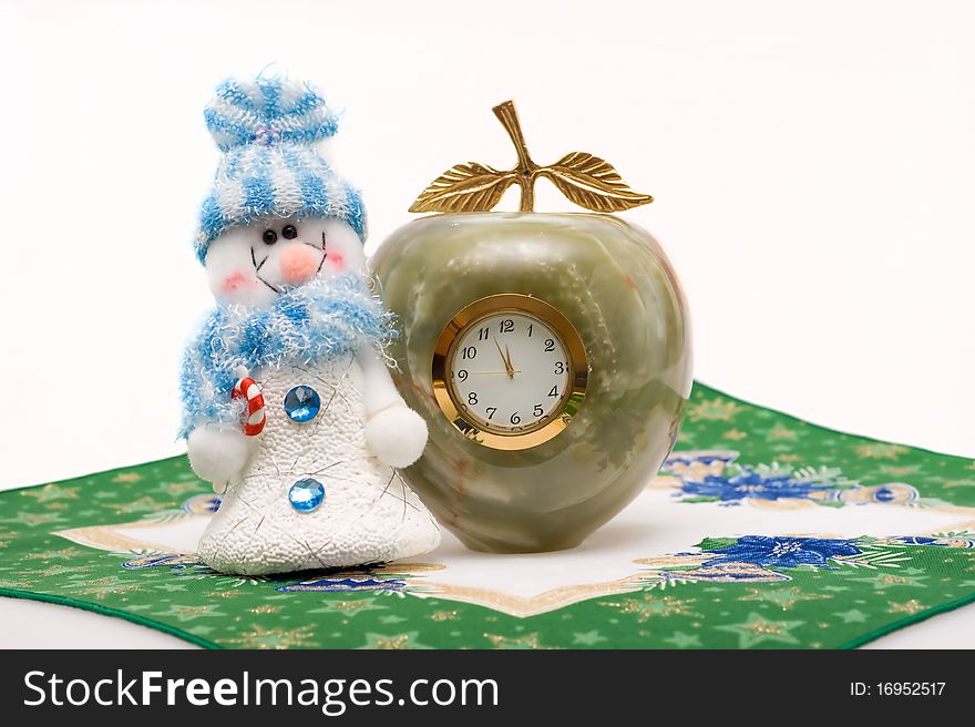 Snowman and clock shows three minutes before the New year on a white background