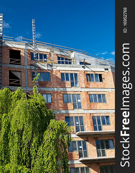 Residential building construction site on a lovely summer day (color toned image)