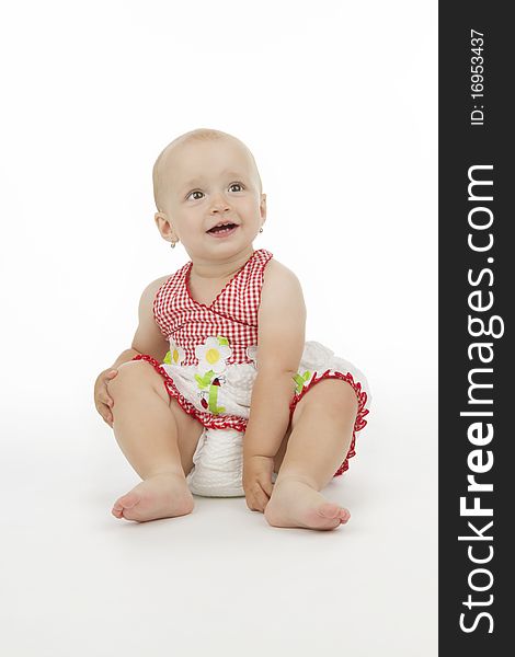 Smiling child sit, on white background.