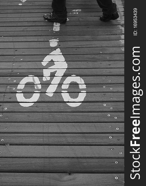 A pedestrian walking on the cycle path on Brooklyn Bridge, New York