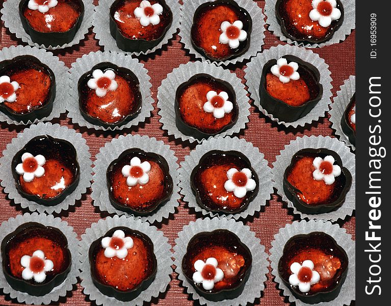 Plate with red chocolates cookies. Plate with red chocolates cookies