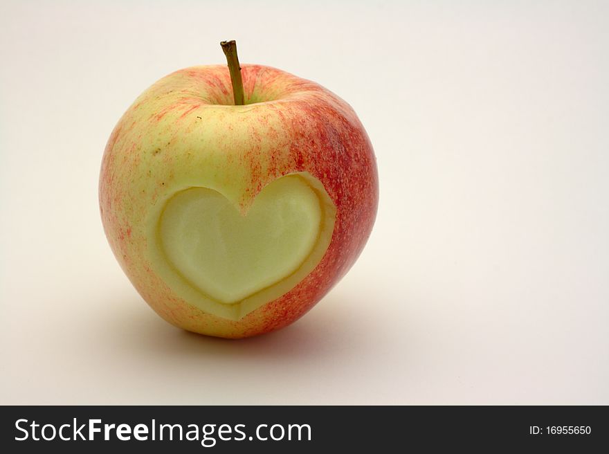 Heart shape carved into red apple. Heart shape carved into red apple