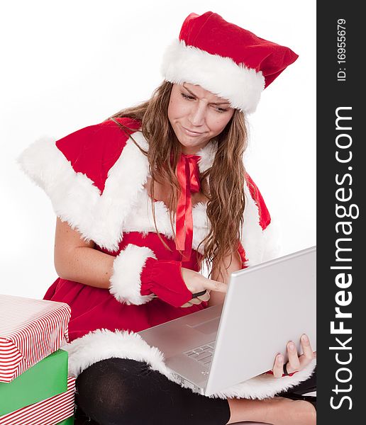 Mrs Santa pointing at computer with a scowl
