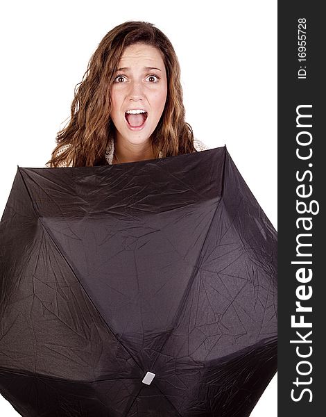 A woman is looking over a black umbrella. A woman is looking over a black umbrella