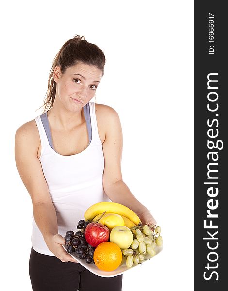A woman is holding a plate of fruit. A woman is holding a plate of fruit.