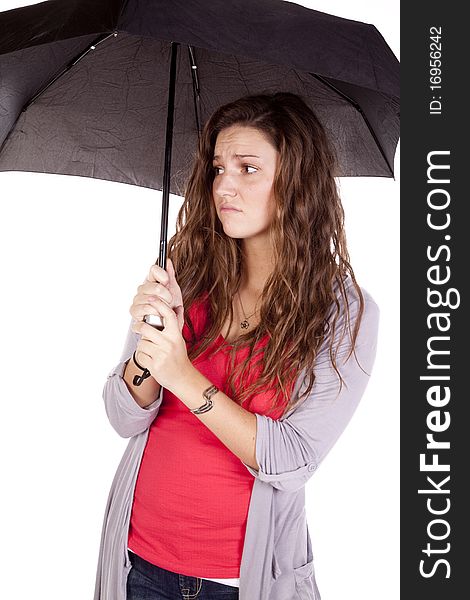 A woman under an umbrella looks frustrated. A woman under an umbrella looks frustrated.