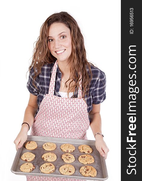 A woman is holding a pan of cookies. A woman is holding a pan of cookies.