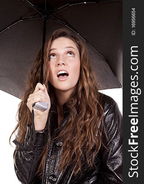 A woman is standing under a black umbrella. A woman is standing under a black umbrella.