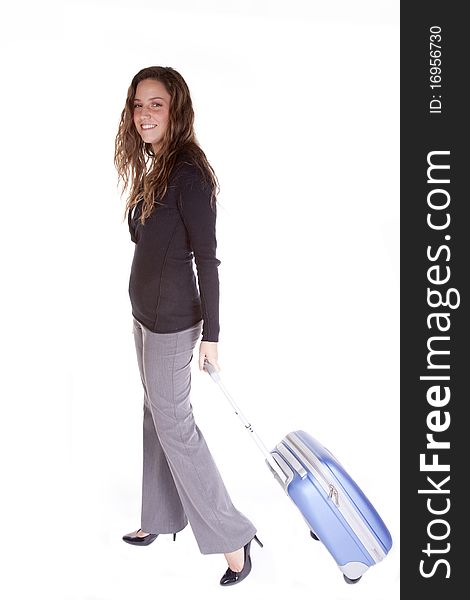 A business woman is pulling a blue suitcase. A business woman is pulling a blue suitcase.