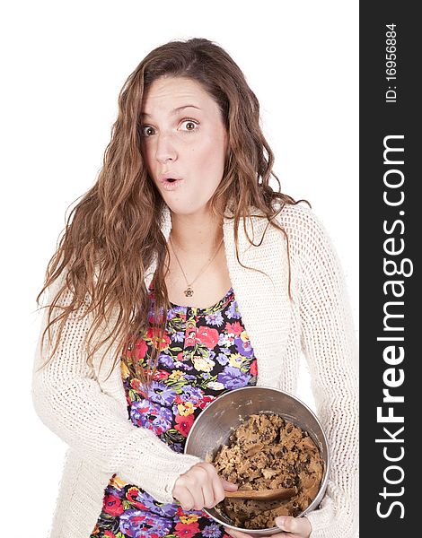 A happy woman is stirring a bowl of cookie dough. A happy woman is stirring a bowl of cookie dough.