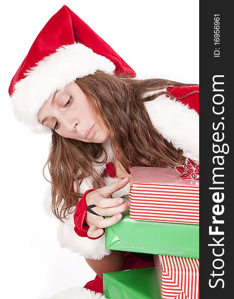 A woman is dressed in Christmas attire looking at gifts. A woman is dressed in Christmas attire looking at gifts.