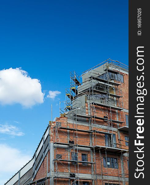 Residential building construction site on a lovely summer day (color toned image)