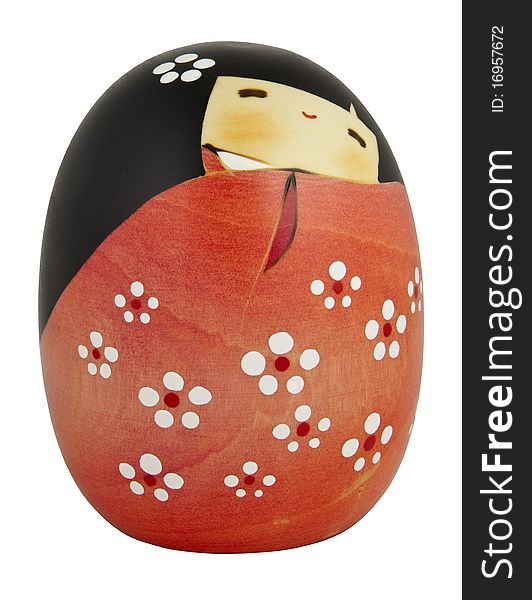 Unique, wooden kokeshi doll handcrafted in Japan (cut-out on white background).