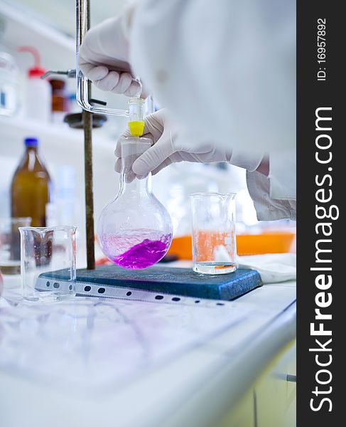 female researcher doing research in a lab (color toned image; shallow DOF)