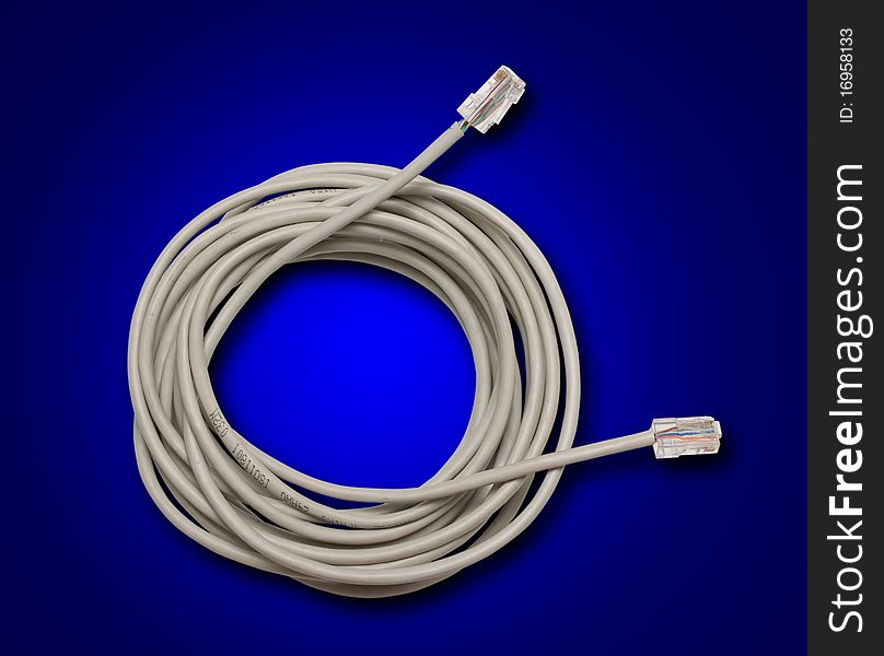 Network cable irregularly wound in a roll on a dark blue background