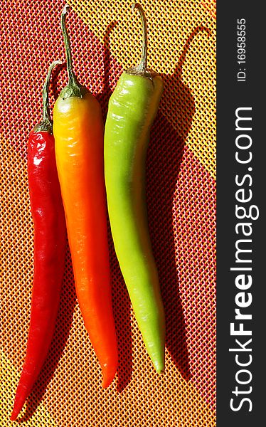 Three - colored pepper on a color background. Three - colored pepper on a color background