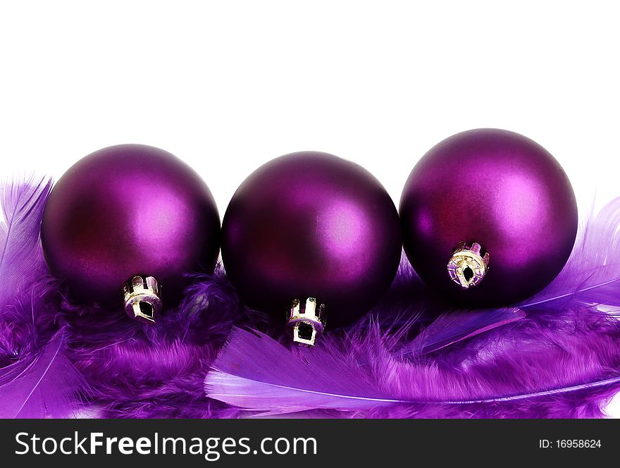 Lilac New Year's spheres in feathers on a white background. Lilac New Year's spheres in feathers on a white background