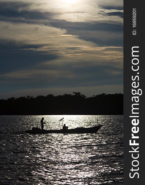 Two fishermen in a boat on the river