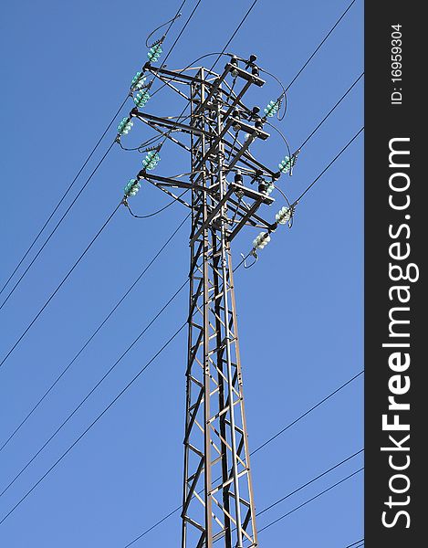 A power tower in front a blue sky. A power tower in front a blue sky