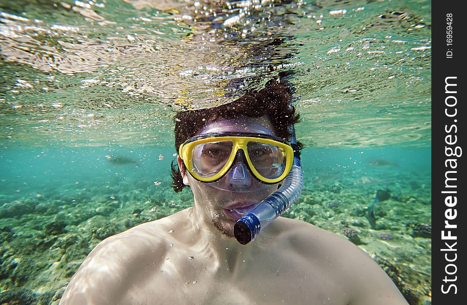 Man with a goggles in the sea