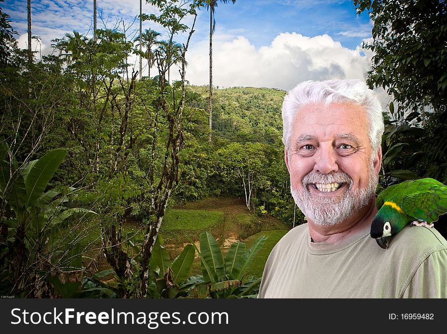 Mature man with parrot on shoulder standing in tropical forest. Mature man with parrot on shoulder standing in tropical forest.