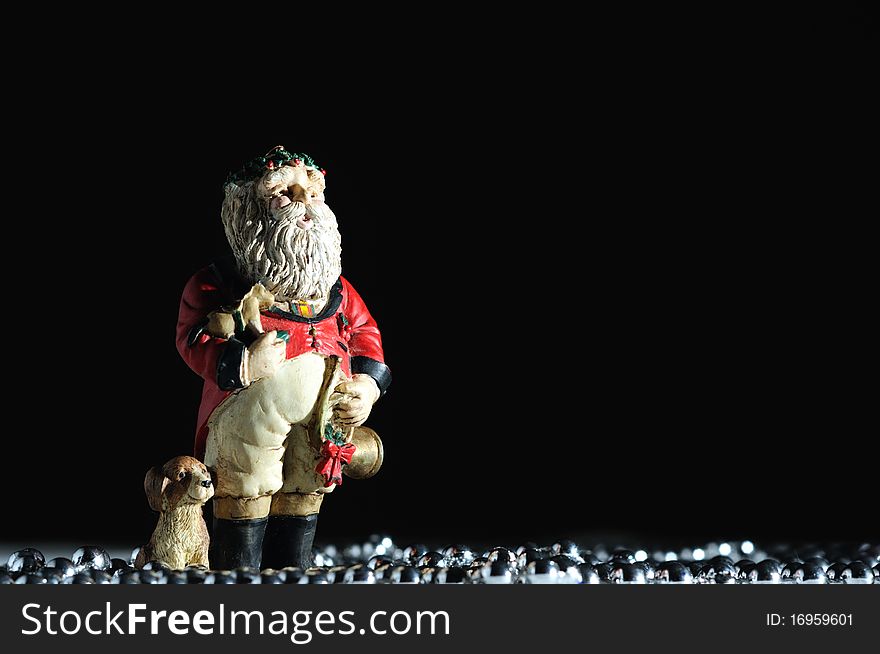 Santa Claus decoration standing with puppy dog, holding french horn and a toy rocking horse. Santa Claus decoration standing with puppy dog, holding french horn and a toy rocking horse