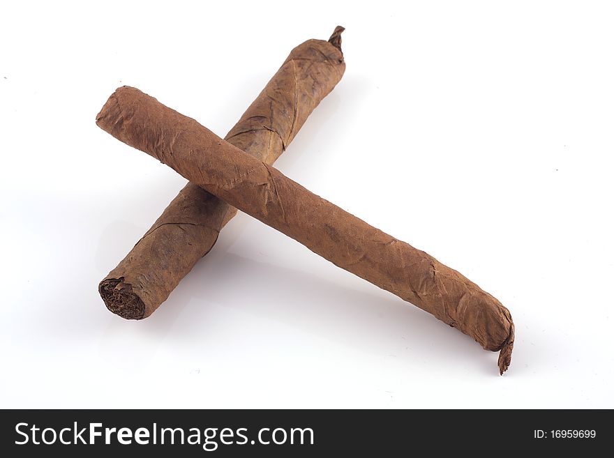 Two handrolled cigars and a cuban humidor isolated on a white background