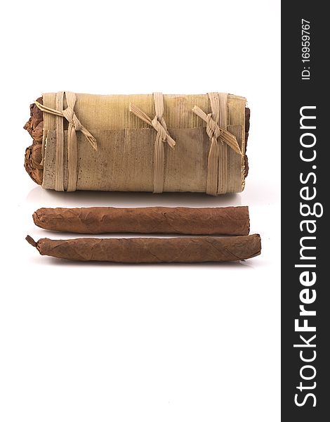 Two hand rolled cigars in front of an authentic cuban humidor, a banana leaf, isolated on a white background