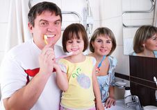 Mom, Daughter And Father Brush Their Teeth Royalty Free Stock Photography