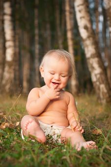 A Little Girl Sitting On Green Grass Stock Photo A Little Girl Sitting On Green Grass Stock Photo