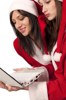 Two Santa Girls With Laptop Royalty Free Stock Photography