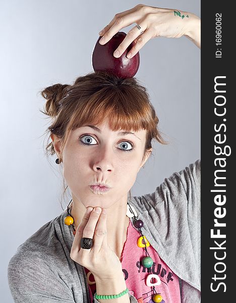 Girl with apple on white background