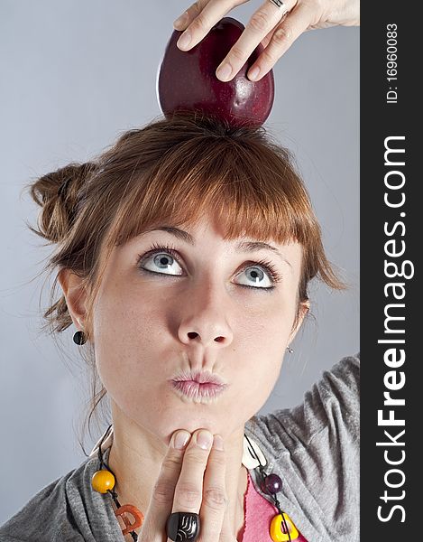 Girl with apple on white background