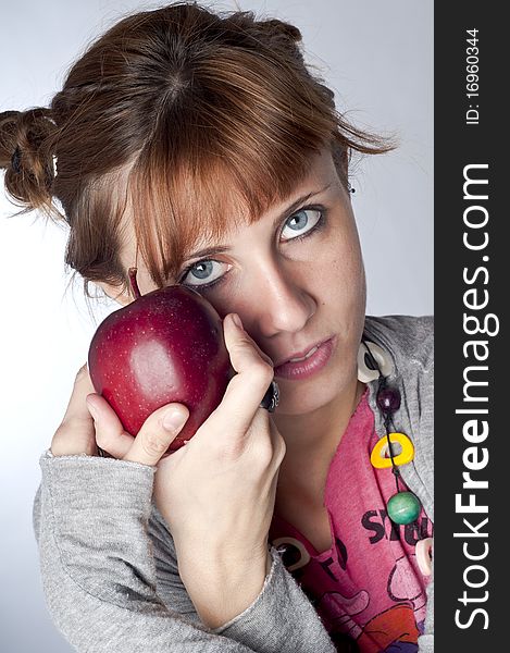 Girl with apple on white background