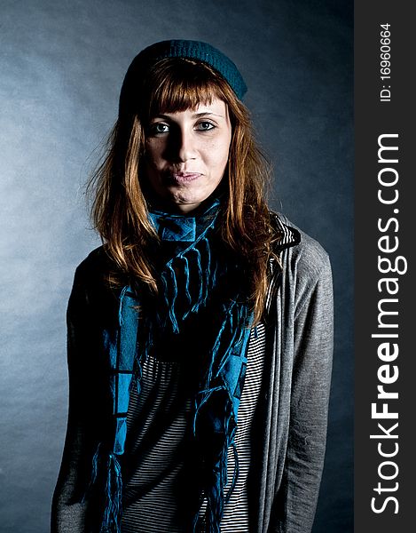 Beautiful girl with scarf and hat on a black background