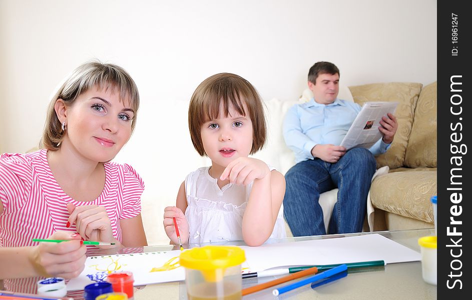 Mother and daughter together paint an album and have fun together.