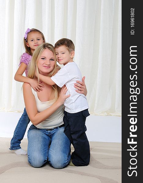 A young mother, her daughter and son having fun together