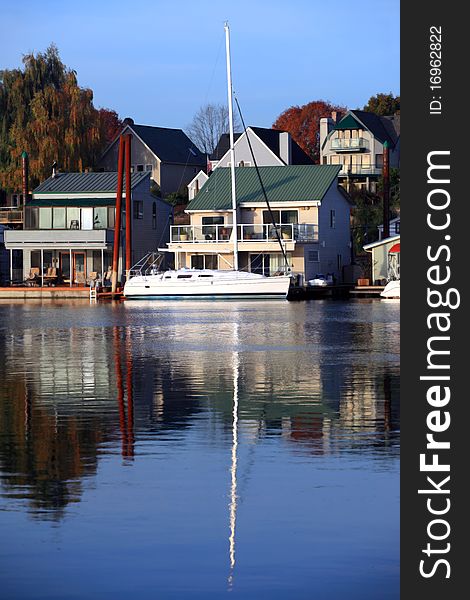 A parked yacht and floating homes on the river. A parked yacht and floating homes on the river.