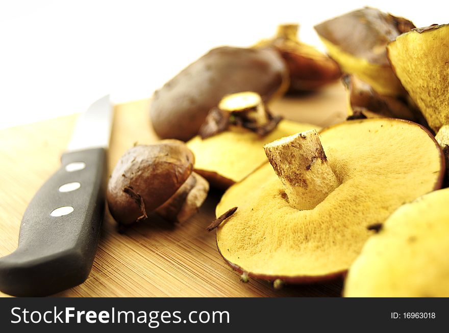 Mushrooms and knife on a kitchen board