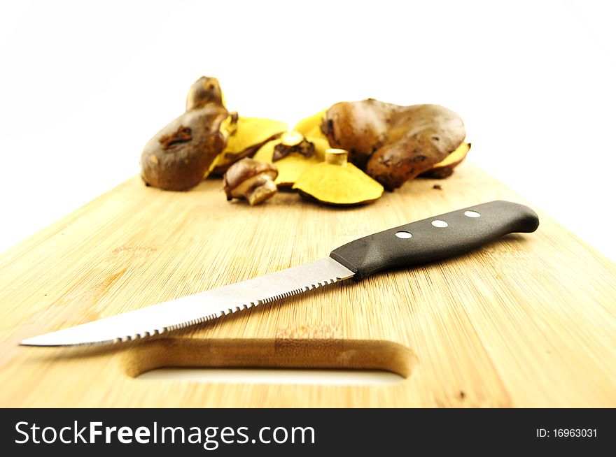 Mushrooms and knife on a kitchen board