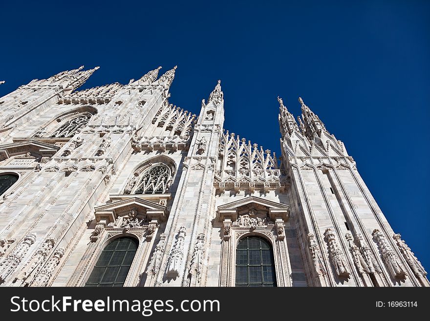 Cathedral facade in Milan and against a clear, blue sky. Cathedral facade in Milan and against a clear, blue sky