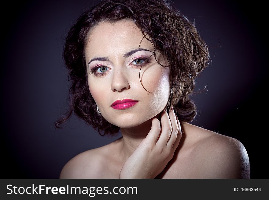 Beauty portrait of a young brunette girl with curly hair and pink lips. Beauty portrait of a young brunette girl with curly hair and pink lips